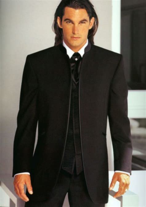 A Man In A Black Suit And Tie