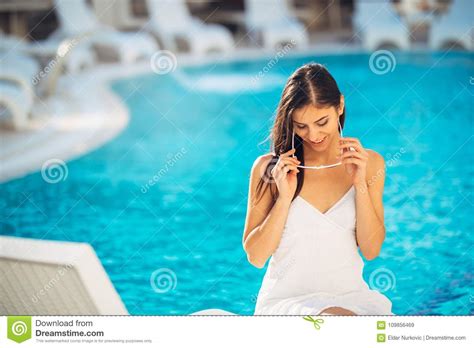 Attractive Young Woman Relaxing At Nluxury Vacation Resort Pool
