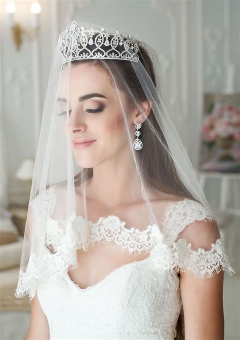 A Woman Wearing A Wedding Veil And Tiara
