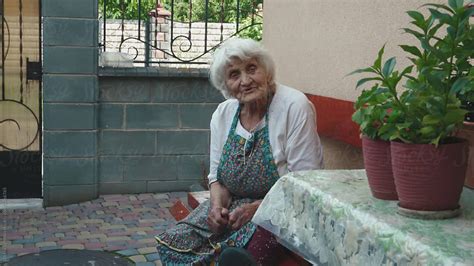 Granny Resting Outside Near Her Home By Oleksii Syrotkin