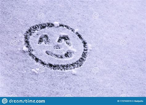 Smiling Happy Emoticon Drawn On Snow On Windshield Welcoming And
