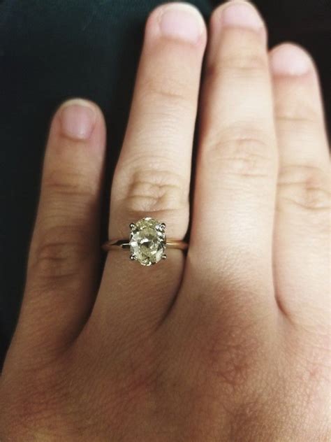 Yellow diamond rings are awesome alternatives to traditional transparent stones. Solitaire fancy light yellow oval diamond engagement r ...