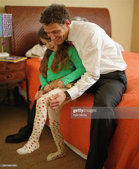 Father Helping Daughter To Put On Tights Bildbanksbilder Getty Images
