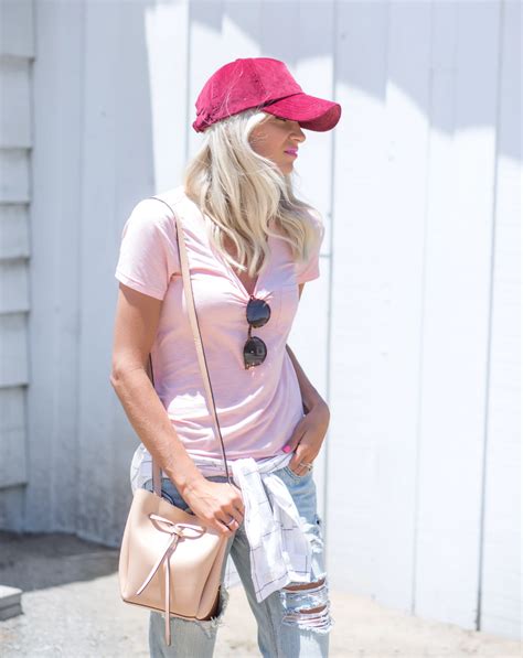 How To Wear A Baseball Cap And Look Stylish Purewow White Baseball Cap Outfit Cap Outfit