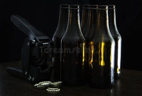 Hand Capper With Five Dark Brown Bottles And Caps Stock Photo Image