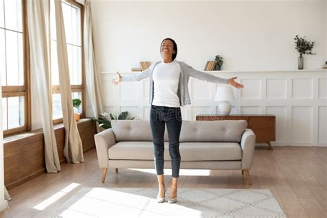 Happy African American Woman Dancing At Home In Living Room Stock Image