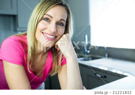 Pretty blonde woman leaning on the counterの写真素材 PIXTA