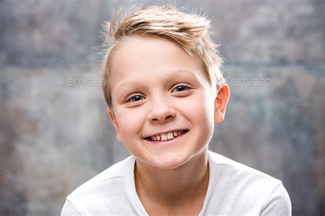 Close Up Portrait Of Cute Little Boy Smiling At Camera Stock Photo By