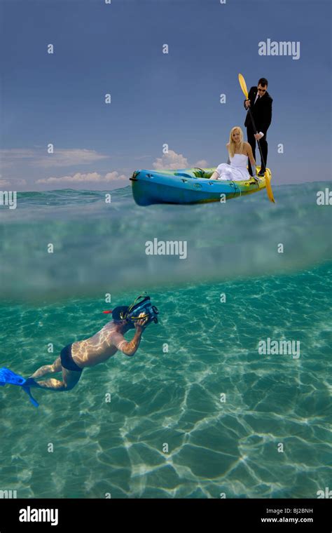 digital composite a cameraman is filming underwater a just married couple on a kayak stock