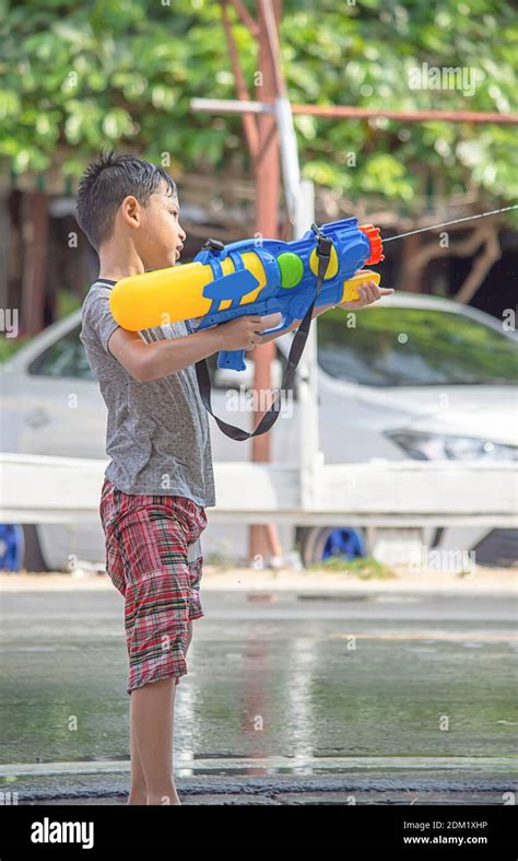 Boy Playing With Squirt Gun Outdoors Stock Photo Alamy