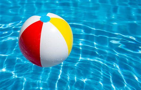 A Beach Ball Floating In A Blue Pool Stock Photo Download Image Now