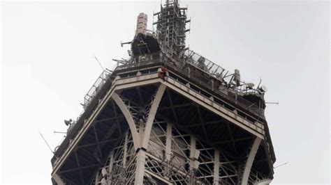 climber illegally scales eiffel tower over six hours gripped magazine