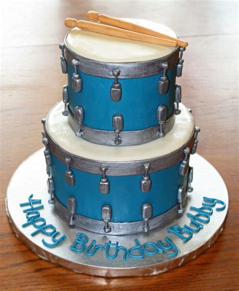 A Birthday Cake With Blue Drums On It