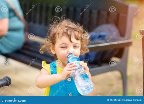Little Girl Drinking Water From The Bottle Stock Photo Image Of Happy