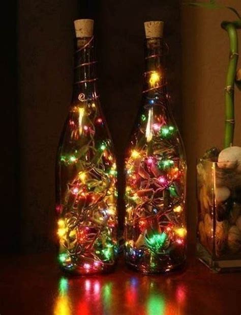 Two Bottles Filled With Lights Sitting On Top Of A Table