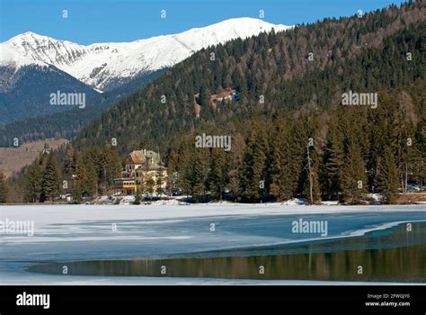 Dobbiaco Lake In Winter With Historic Hotel Baur Pusteria Valley