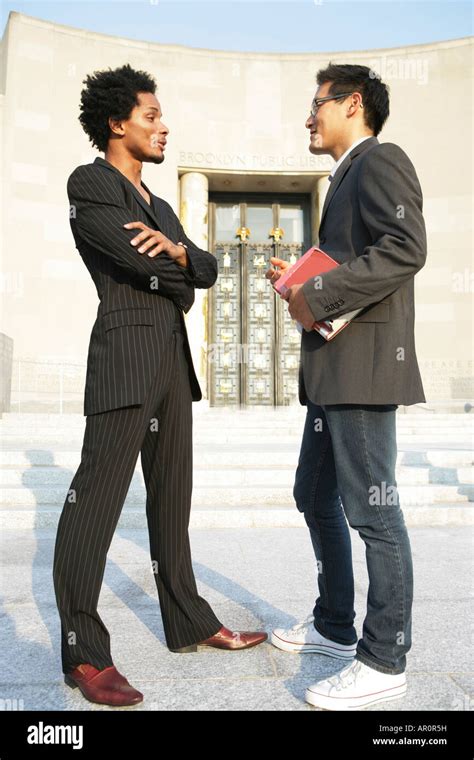 Two Men Standing Face To Face Talking Stock Photo Alamy