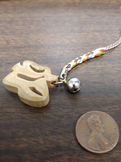 Found on sidewalk. Is this wooden pendant supposed to look like anything in particular 