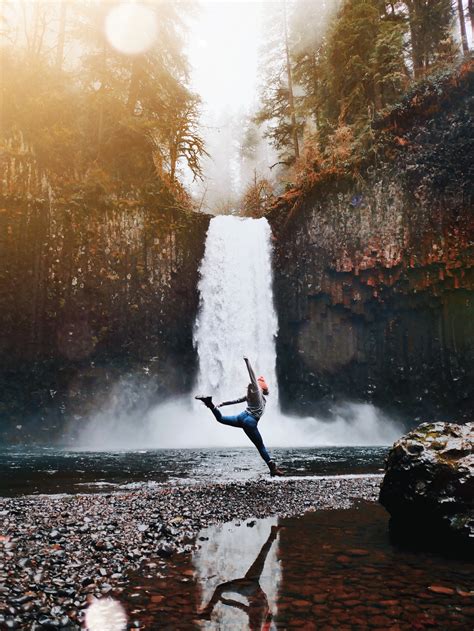 Person Posing Across Waterfall · Free Stock Photo