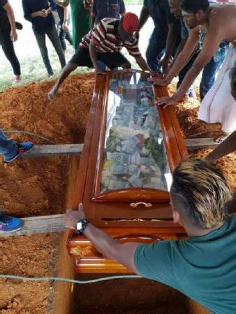 buried in cash see how a man buried his father in glass top coffin filled with thousands of