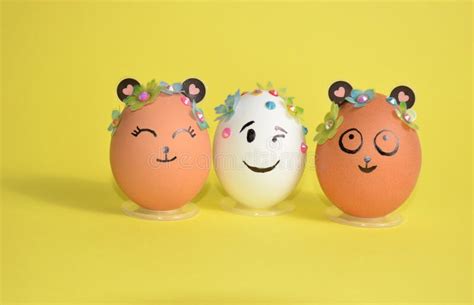 Three Easter Eggs With Cute Faces On A Yellow Background Spring