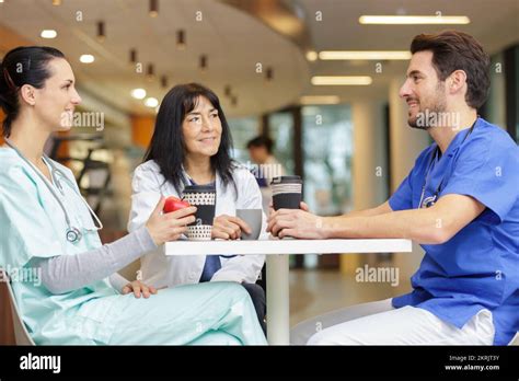 three healthcare workers having a break Stock Photo - Alamy