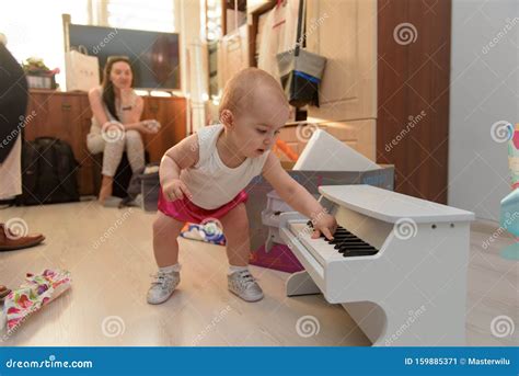 Beautiful Baby Girl Playing Toy Piano In Light Room Stock Image Image