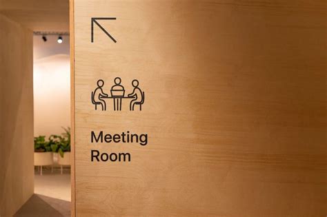 The Meeting Room Black Sign On The Wooden Wall With Direction Sign And