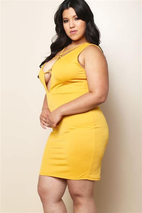 A Plus Size Sleeveless Mini Bodycon Dress With A Deep V Neckline And Strap Details Features A