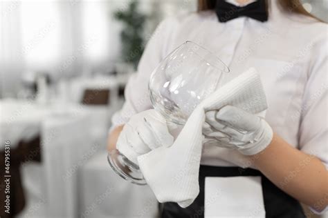 Close Up Of A Glass And A Towel In The Hands Of A Waiter Preparation