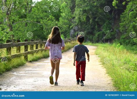 Friends Walking In Nature On A Path Through Forest Stock Image Image