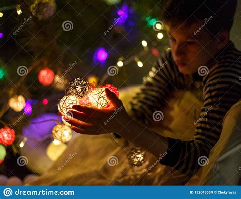 Kids Hands Hold A Ball Garland For Christmas Or New Year