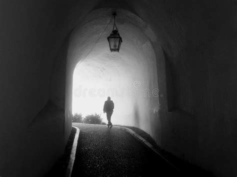 Man Walking Towards Light Stock Image Image Of Photograph 265884963