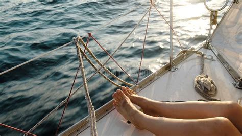 Female Legs Feet On The Sailing Yacht Closeup In The Open Sea Stock