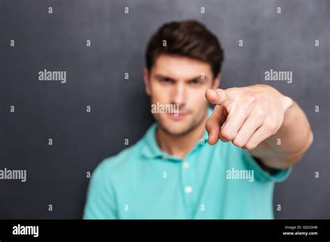 Close Up Portrait Of A Handsome Man Pointing Finger At Camera Isolated