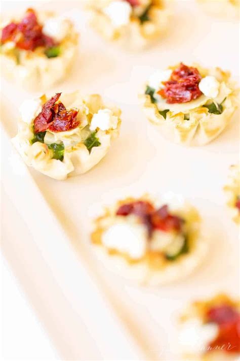 Small Appetizers Are Arranged On A White Tray