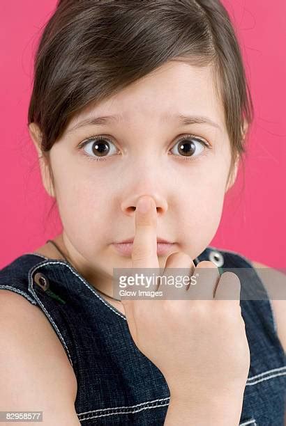 person touching nose with finger stock fotos und bilder getty images