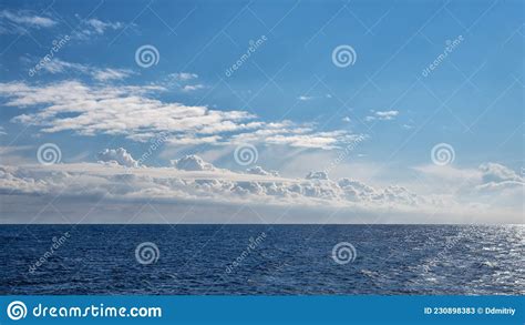 A Front Of Cumulus Clouds Over A Shiny Sea Stock Image Image Of