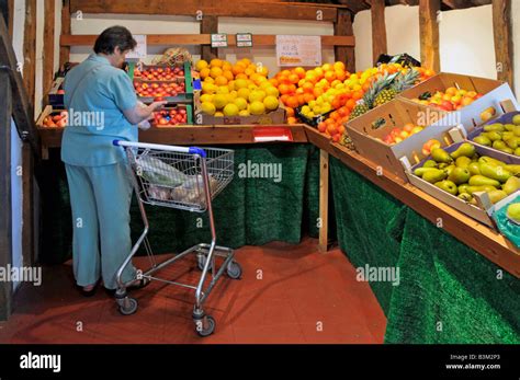 Interior Of Retail Farm Shop Fruit Produce On Display Woman Shopper And