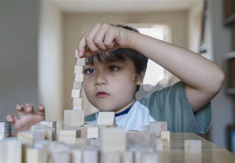 Selective Focus Smart Kid Building The Tower Stack From Wooden Blocks