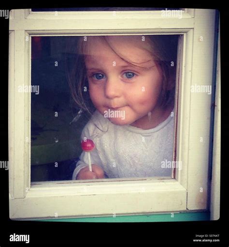 Girl In A Window Stock Photo Alamy