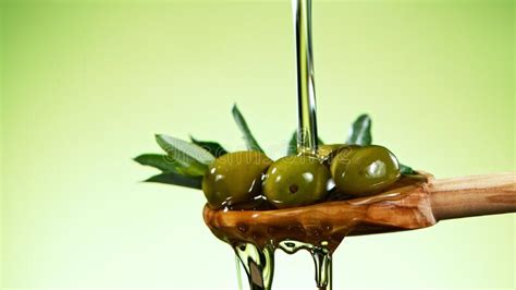 Macro Shot Of Pouring Olive Oil On Green Olives Stock Photo Image Of