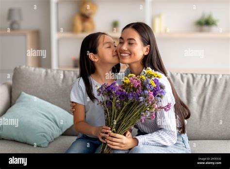 I Love You Mommy Pretty Asian Girl Kissing Her Mum In Cheek And