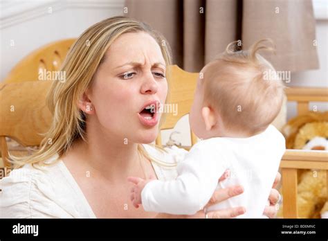 Stressed Mother Holding Baby In Nursery Stock Photo Alamy