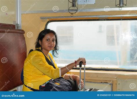 Young Indian Woman Traveling By Train With Luggage Bags Travelling In Public Transport In India