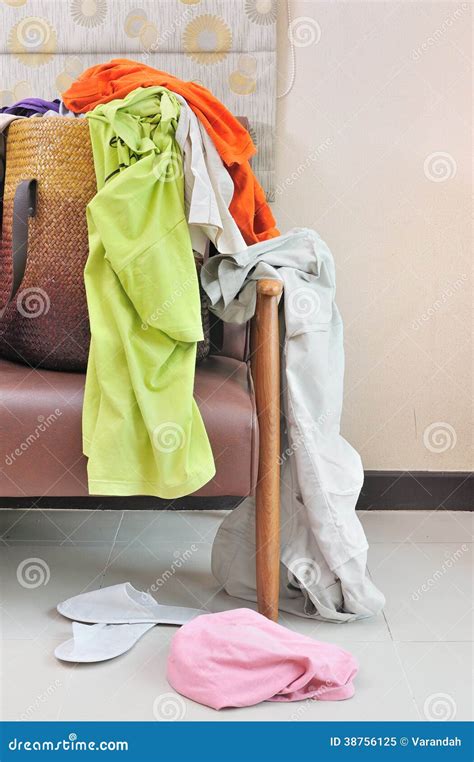 Messy Clothes Scattered On A Leather Sofa Royalty Free Stock Photo