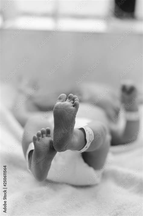 A Black And White Images Of A Newborn Babys Feet In The Neonatal Unit