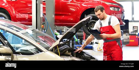 Car Mechanic In A Workshop Repairing A Vehicle Stock Photo Alamy