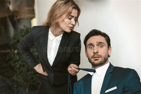 Female Boss Seduces Employee Young Girl Holds By The Shoulders Of A Colleague Who Is Sitting At