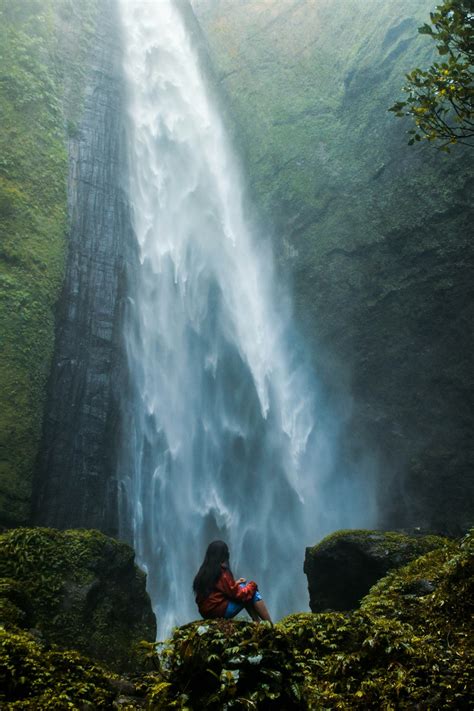 Woman Sitting On Rock Facing Plunge Waterfalls Photo Free Lady Image